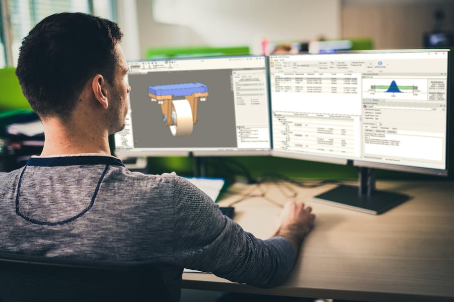 Male engineer looking at computer with Sigmetrix CETOL software on screen