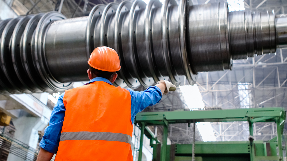a person working in a manufacturing facility after reading the ASME Y14.5 Ultimate Guide
