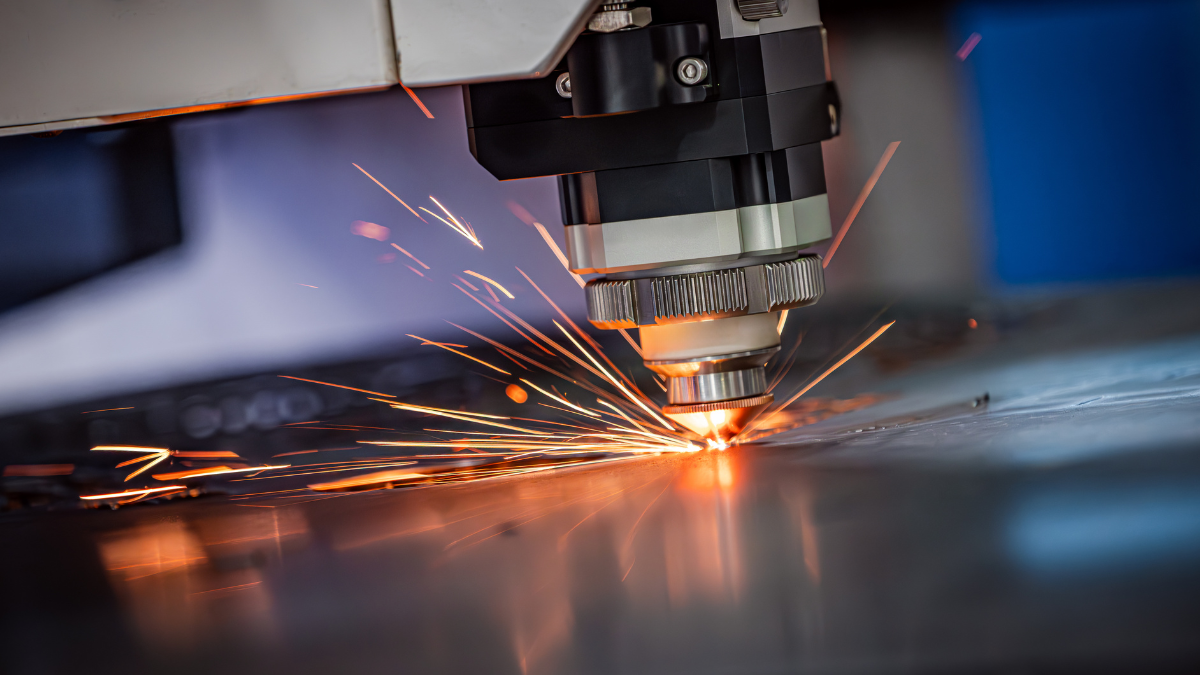 a CNC machine cutting out metal while adhering to DFM principles. 
