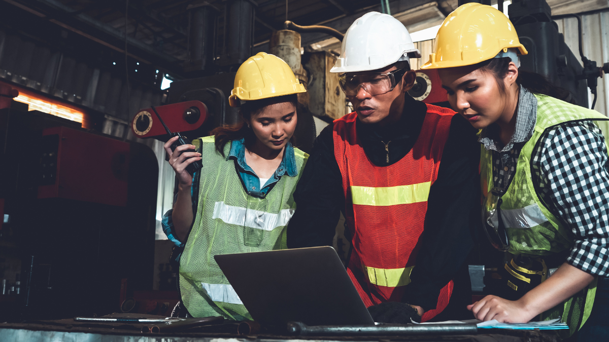 a team of 3 people discussing which product development consultant they should choose while looking at a laptop