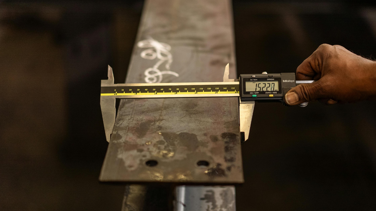 calipers measuring a piece of steel